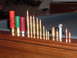 1995 Mercury Grand Marquis - Various types of ammunition are displayed in a row on a wooden surface.