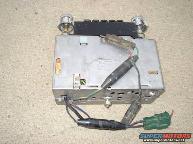 Ford car radio with two knobs and wiring, seen from above