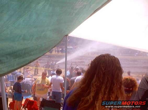 Outdoor event scene with people and water spray