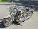 1999 Harley-Davidson Fat Boy - A custom motorcycle with extensive chrome accents and unique detailing on the front fender is parked outdoors.