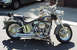 1999 Harley-Davidson Fat Boy - A custom motorcycle with chrome accents and an eagle painted on the fuel tank sits on a paved surface.