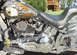 1999 Harley-Davidson Fat Boy - Close-up of a motorcycle's custom painted gas tank an eagle, alongside its engine and seat.