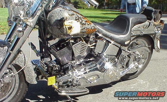 Side view of a custom motorcycle with an eagle graphic on the fuel tank and chrome accents