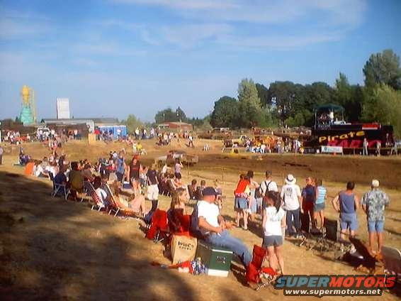 Mud run event scene with spectators and a large truck labeled "Pirate Rad"