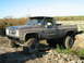 1990 Ford Bronco - This lifted pickup truck is covered in mud after an off-road excursion.