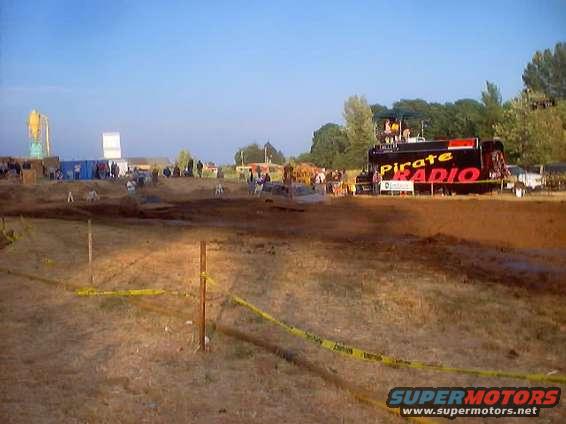 Mud pit event with a truck labeled 'Pirate Radio' and spectators in the background