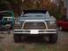1978 Ford Bronco - This Ford Bronco features a prominent grille and a custom bull bar, with other vehicles visible in the background.