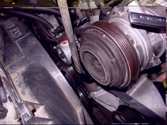 Engine bay view of AC compressor and fan with visible text 'UNION FAN'