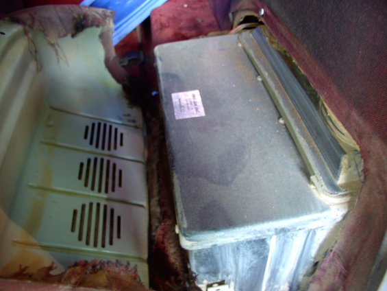 Vehicle AC unit with a sticker on it, next to a vent panel
