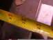 1988 Ford C-350 (Centurion Conversions) - A close-up of a yellow measuring tape shows markings for feet and inches, indicating measurements.