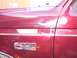 1988 Ford C-350 (Centurion Conversions) - Close-up of the side of a red 1988 Ford C-350 truck, showing the fender and door badges.