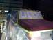 1988 Ford C-350 (Centurion Conversions) - Truck undergoing paint preparation, covered in protective sheeting and taped signs.
