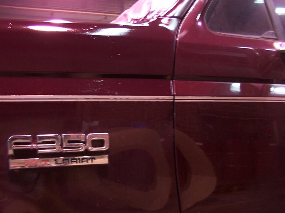 Maroon truck side panel with F-350 Lariat badge