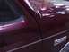 1988 Ford C-350 (Centurion Conversions) - Close-up of a maroon Ford truck's side panel, showing a "350" emblem and chrome trim.