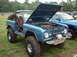 1978 Ford Bronco - A blue 1978 Ford Bronco is displayed with its hood open, revealing the engine and a front-mounted winch.