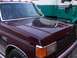 1988 Ford C-350 (Centurion Conversions) - Maroon Ford F-Series truck with a dark grille and chrome accents, seen from the front quarter angle.