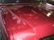 1988 Ford C-350 (Centurion Conversions) - The hood of a vehicle shows significant rust and paint deterioration, revealing underlying metal.