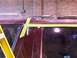 1988 Ford C-350 (Centurion Conversions) - Masking tape is applied to a maroon vehicle's roof and door, preparing for a paint job.
