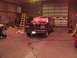 1988 Ford C-350 (Centurion Conversions) - Ford F-Series truck with front end covered in plastic, parked inside a garage.