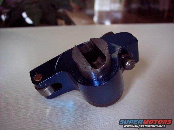Blue metal engine rocker arm with a U-shaped opening