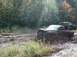 1978 Ford Bronco - Off-road vehicles are stuck in deep mud during an outdoor excursion.