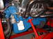 1969 Ford Mustang - Close-up of an engine assembly a blue block, chrome headers, and a Motorcraft oil filter.