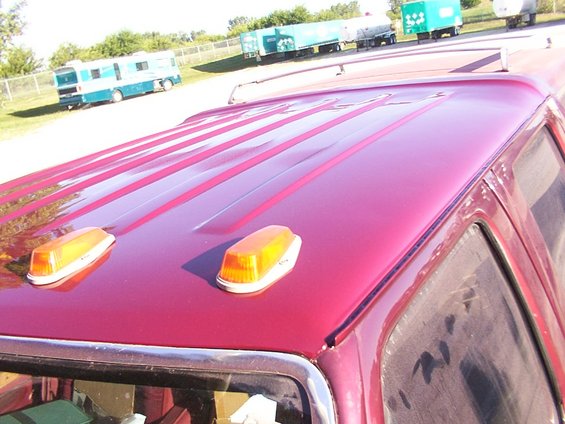 Red truck roof with two amber clearance lights and raised body lines