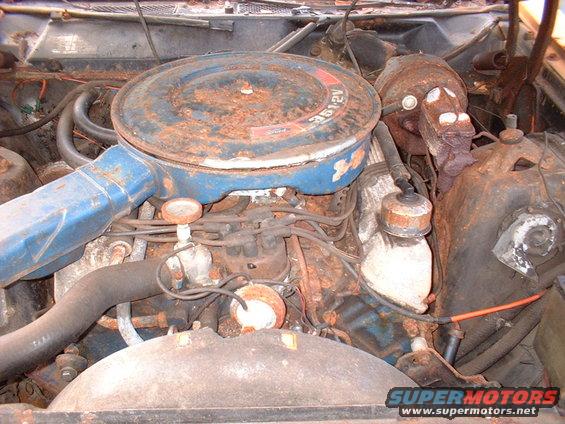 Engine bay showing a V8 engine with a blue air cleaner. Text on air cleaner reads 351 2V