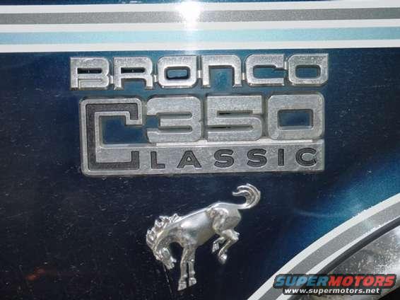 Bronco C350 Classic emblem and horse emblem on a dark blue surface