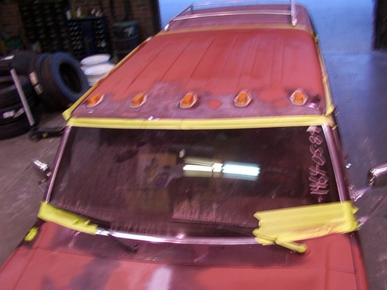 Red truck roof with five amber clearance lights, masked for paint. Text '1464-05-88' written on windshield