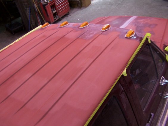Truck roof with amber clearance lights, taped off for paintwork