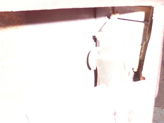 Close-up of a door lock motor assembly inside a vehicle