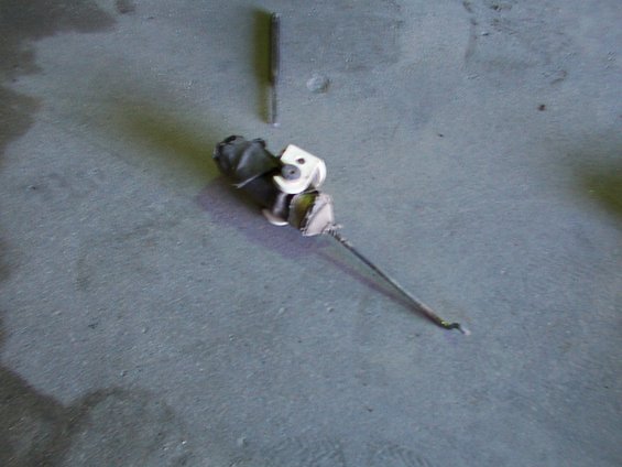 Door lock actuator rod with black plastic housing and metal rod