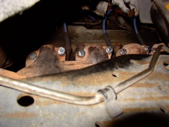 Exhaust manifold with spark plug wires attached to bolts