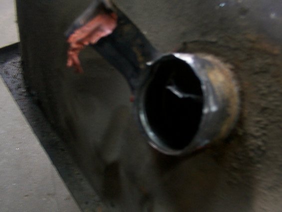 Close-up of a damaged fuel pump part with a torn red material