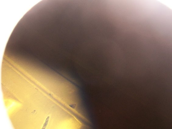Close-up of a metallic fuel pump component with some discoloration