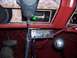 1985 Ford Bronco - The interior of the vehicle features a CB radio and a 4x4 gear shifter, along with a microphone and keys.