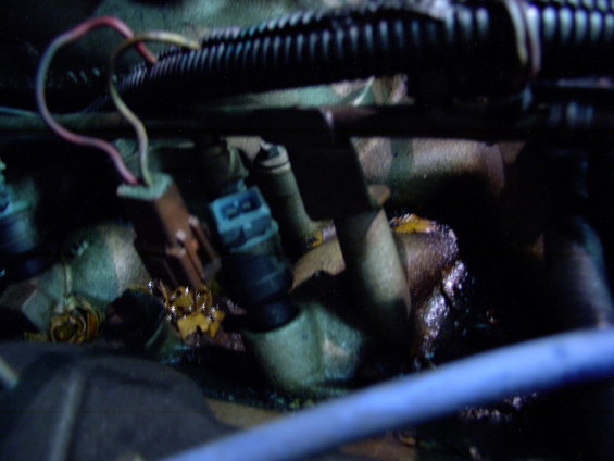 Close-up of fuel injectors with electrical connectors and wiring
