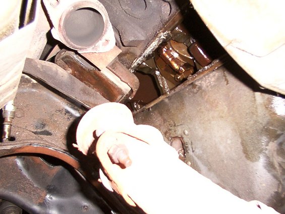 Engine oil pan with visible crankshaft and connecting rod