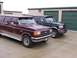 1988 Ford C-350 (Centurion Conversions) - Two Ford trucks, a maroon one and a dark green one, are parked in front of storage unit doors.