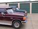 1988 Ford C-350 (Centurion Conversions) - Two Ford trucks are parked in front of storage units.