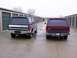 1988 Ford C-350 (Centurion Conversions) - Two Ford Broncos with camper shells parked in front of storage units on a cloudy day.
