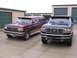 1988 Ford C-350 (Centurion Conversions) - Two Ford trucks are parked outside storage units on a cloudy day.