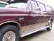 1988 Ford C-350 (Centurion Conversions) - Maroon Ford F-350 extended cab pickup truck with tan lower body trim and running boards, viewed from the side.