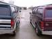 1988 Ford C-350 (Centurion Conversions) - Two Ford SUVs, possibly Centurion conversions, are parked facing each other in a storage unit lot.