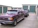 1988 Ford C-350 (Centurion Conversions) - Two vehicles are parked in front of beige and green storage unit doors.