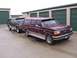 1988 Ford C-350 (Centurion Conversions) - Two Ford SUV conversions are parked side-by-side in front of storage unit doors.