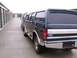 1988 Ford C-350 (Centurion Conversions) - Rear view of a 1988 Ford C-350 Centurion Conversion van, parked in a row with other vehicles.