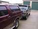 1988 Ford C-350 (Centurion Conversions) - Two SUVs are parked in front of storage units. The front vehicle appears to be a 1992 Ford F-Series SUV.