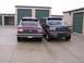 1988 Ford C-350 (Centurion Conversions) - Two Ford trucks are parked in front of storage units on a cloudy day.